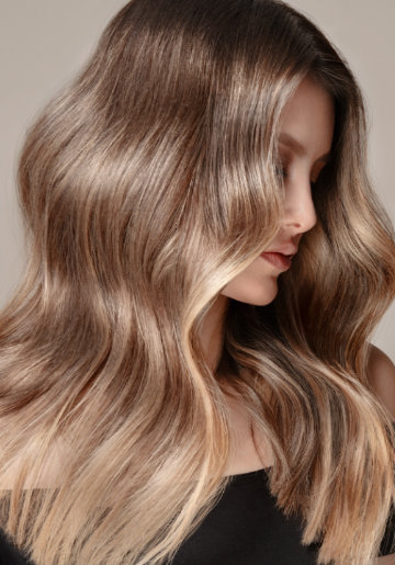 Women viewed from side with long bright blonde hair