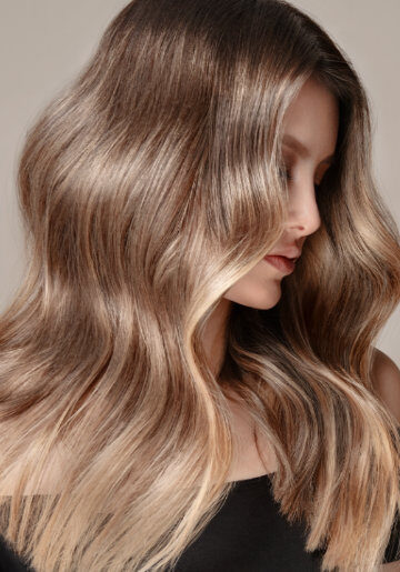 Women viewed from side with long bright blonde hair